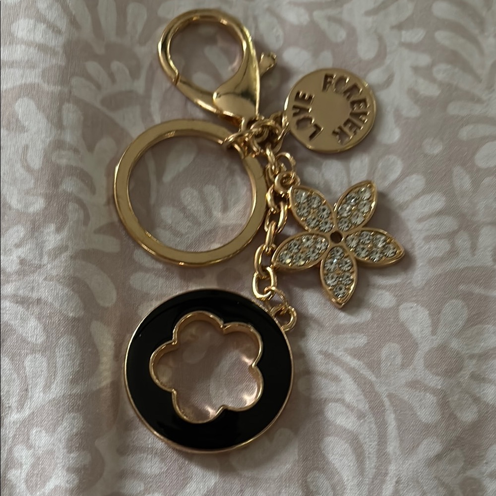 NWOT Fashion Flower shaped keychain. Gold and Black with Floral Rhinestones.